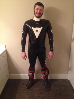 rbrlover:  Handsome pup Biff in rubber Dainese suit 