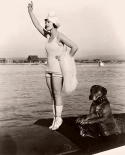 Gloria Swanson (1899 - 1983) stands on tiptoes on the prow of