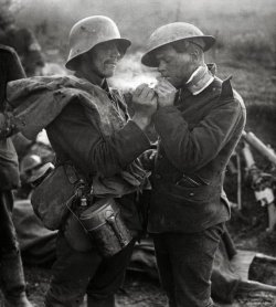 collective-history:  German soldier, giving a cigarette to an