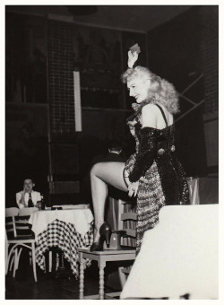 Lynne O’Neill flashes her leg to the audience, during a performance