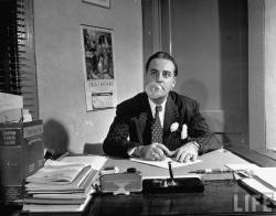 Cornell Capa - Bubble Gum King Andrew J. Paris sitting at desk