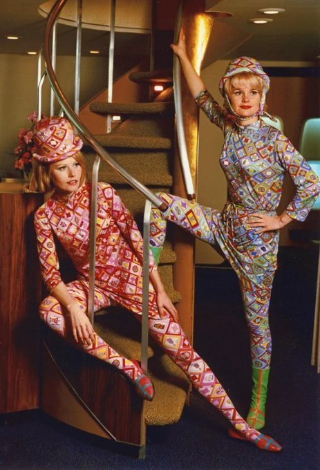 Braniff Airlines flight attendants posing in their groovy uniforms