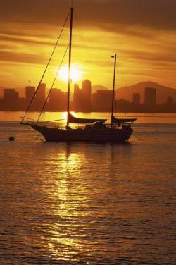 creativetravelspot:  ✭ Silhouetted sailboat at sunrise with