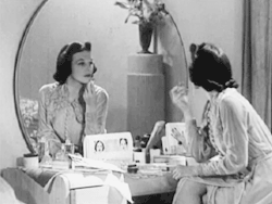 publicdomaindiva:  Applying lipstick in Fitting Faces (1940).