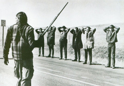 historicaltimes: American Indian Movement Member Stands with