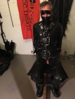 jamesbondagesx:  Rubber gimp strapped to chair, gagged, head
