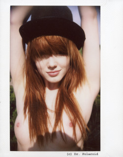 Cute redhead with perky breasts in a hat.