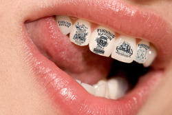 sixpenceee:  Tooth tattoos have been a trend. They are just as