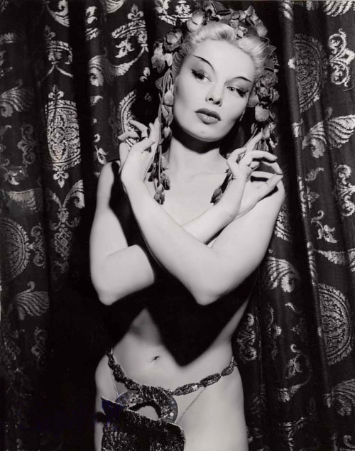 Lili St. Cyr        (aka. Marie Van Schaack)“In one of her early shows, she used a gold  Buddha placed on an altar inside a Chinese pavilion. To soft  Asian-inspired music, her movements told the story of a young bride  whose husband imprisoned