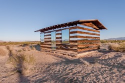 dezeen:  Mirrors were added to the walls of this desert shack