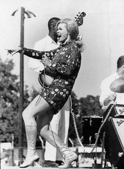 beatnikdaddio:Candy Barr performs on stage at the 1968-edition of the ‘Texas Prison Rodeo’.. Country singers Loretta Lynn and Ray Price, also appeared on the playbill..