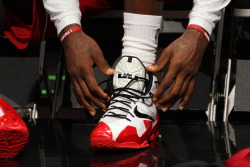 nba:   LeBron James #6 of the Miami Heat laces up his sneakers