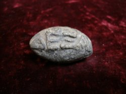 giwatafiya:systlin:museum-of-artifacts:  Lead sling bullet, inscribed