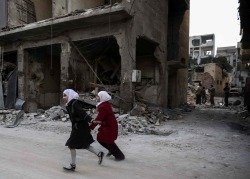 biladal-sham:  Two Syrian girls on a heavily damaged street in