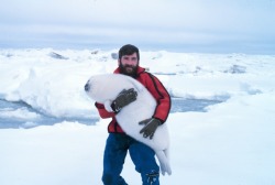 awwww-cute:  A man carrying a ribbon seal pup