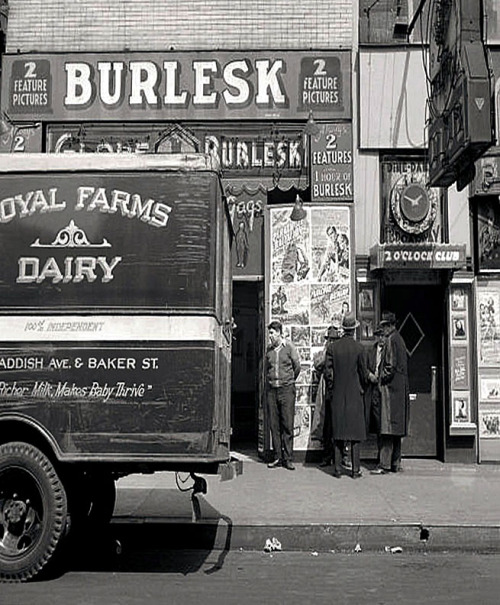 A vintage photograph features both the ‘GLOBE Burlesk’ theatre and the famed '2 O'Clock Club’ in Baltimore, Maryland.. As photographed by Marjory Collins, in 1943.. I’m pretty certain the barker seen (at Left) in this photo is