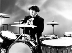 Alfred Hitchcock wearing a Beatle wig, 1964.