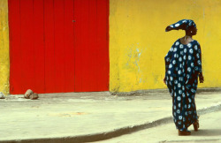 20aliens:  IVORY COAST. Abidjan. A woman contributes to a colourful