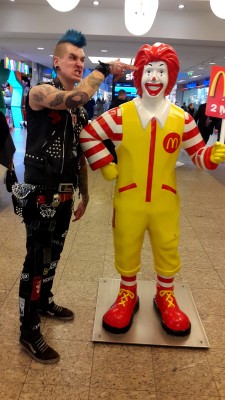 punkerskinhead:  great looking punk with the gear and blue mohawk   My first thought here was Ronald being super rubbers and when the punk  touches the statue he gets gooped. If this was a @blogshirtboy fantasy he would become a girl ronald.