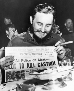 historicaltimes: Fidel Castro holds up a newspaper headlining