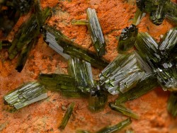 underthescopemin:  Olivenite The bright orange matrix mineral