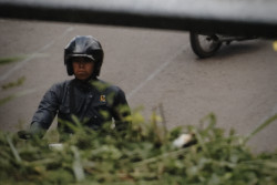 Man makes a tough face while driving his bike. Bandung, Indonesia
