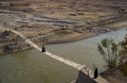 afghanistaninphotos:  A villager makes his way across a bridge