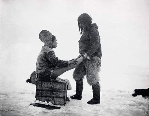 Inuit man warms his wife’s feet, Greenland, 1890’s. Nudes