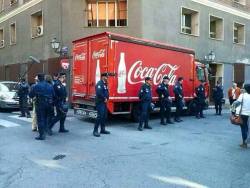 fuckyeahanarchopunk:  Policemen are protecting a Coca Cola truck