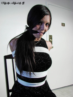 graybandanna:  Brunette in a black dress gagged with a black