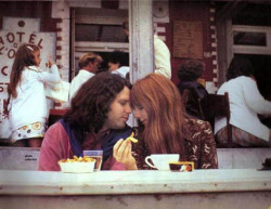 Jim Morrison and Pamela Courson share some fries in Paris, June