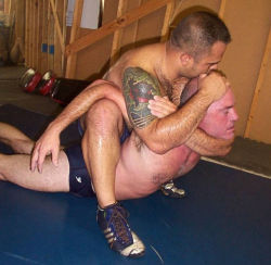 wrestle-me:  Two sweaty wrestlers tangled in what looks like