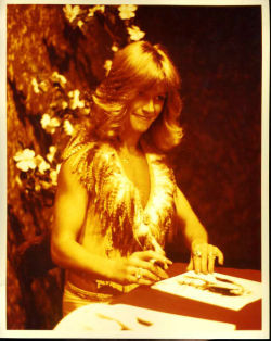 Signing autographs, likely for an appearance promoting Insatiable (1980).