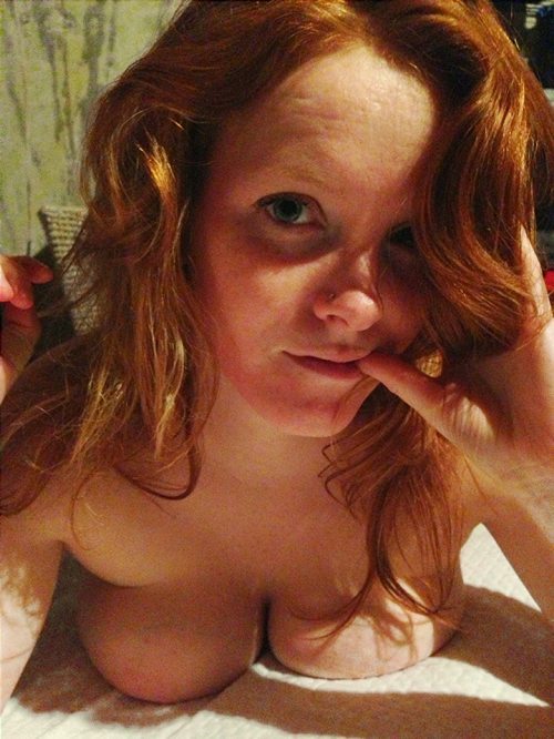 redrule:  Pretty ginger redhead with a close-up, self-shot pic of her lying naked on the bed.