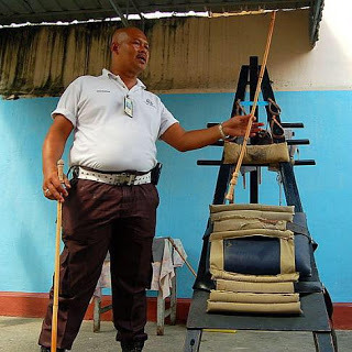  Singapore: The Man With The CaneAnother in our series on Men Who Spank The rattan cane is a terrifically effective tool for correcting bad behavior in adult boys. I speak from experience, not opinion. Looking at the image above, I don’t know which