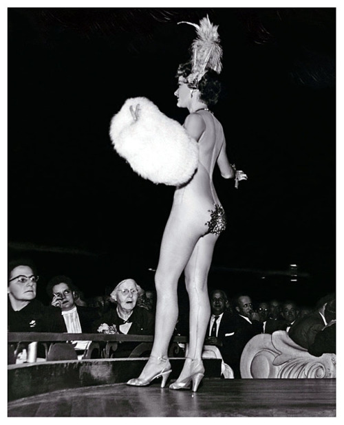 Press photo dated from the mid-50’s features a 77-year old woman attending a performance at NYC’s famed ‘LATIN QUARTER’ nightclub.. The photo accompanied a tabloid magazine’s article detailing her reactions to the nudity displayed