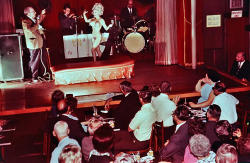 Vintage 60&rsquo;s-era photo captures the emcee of Bourbon Street&rsquo;s famed &lsquo;500 Club&rsquo; introducing an almost-nude Linda Brigette to the stage..