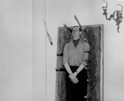  Journalist Macdonald Hastings standing in as a knife thrower’s