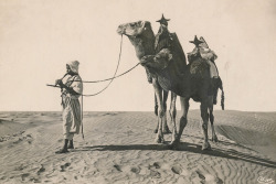 vintageeveryday:Young boy playing flute beside his camels, 1931.