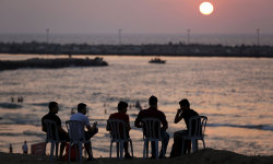 letswakeupworld:  Palestinians sit on the beach in Gaza City