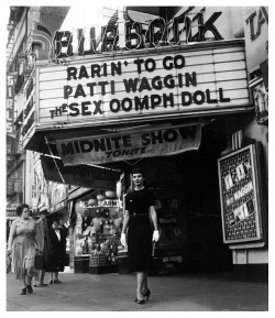  Patti Waggin poses under the marquee of the ‘Burbank Theatre’;