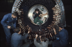 natgeofound:  A female worker helps insulate wires on a large