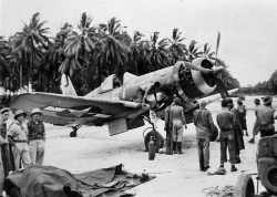 usaac-official:An F4U-1A of VF-17 under maintenance in the Solomons,