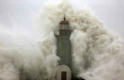 softwaring:  A wave crashes into a lighthouse in Porto, Portugal.