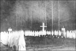 An extremely rare view of a Ku Klux Klan meeting at night in