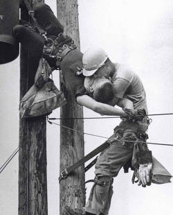 A utility worker giving mouth-to-mouth to a co-worker after he