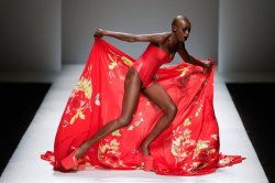 Bald black fashion model stumbling in high heels in China Mercedes-Benz-Fashion-Week,