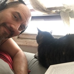 camerasandmirrors:A book, a cat, coffee, and a snowy window.