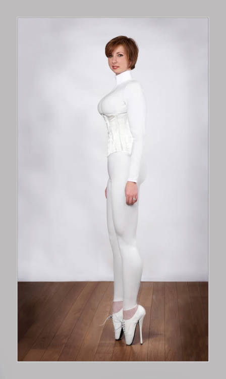 beautifulfetish:  Such mixed messages: the virginal white, the momsy hairstyle, the wedding ring, for God’s sake! And yet she’s posing in corset, latex and ballet shoes. I’m lost!  Bondage and fetish images @  Art of Bondage