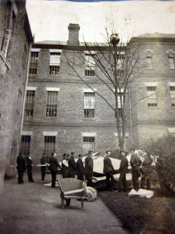 1895. Staff at Colney Hatch Asylum wait for a patient to come